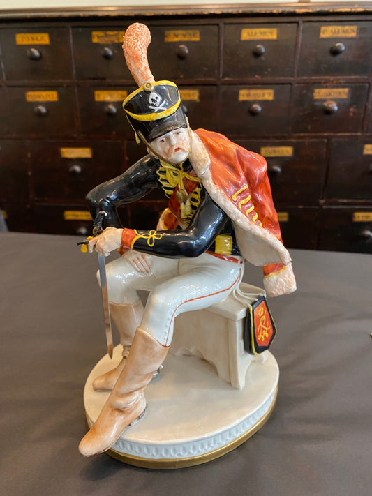 Capodimonte Soldier seated with sword