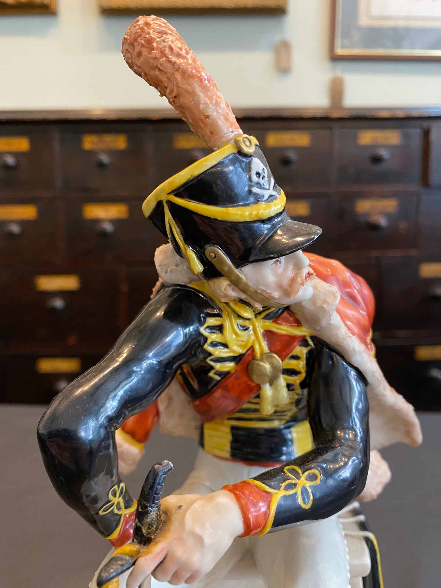 Capodimonte Soldier seated with sword